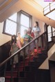 A group of young women standing on a set of stairs.