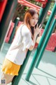 A young woman leaning against a playground equipment.