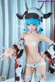 A woman in a cow costume posing for a picture.