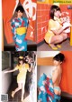 A woman in a yellow and blue kimono posing for a picture.